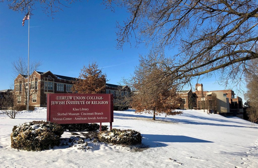 A snow-covered Hebrew Union College campus, the sign prominent in the foreground.